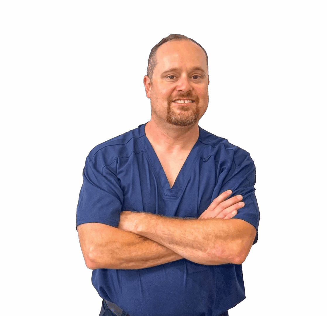 Smiling healthcare worker in blue scrubs, arms crossed